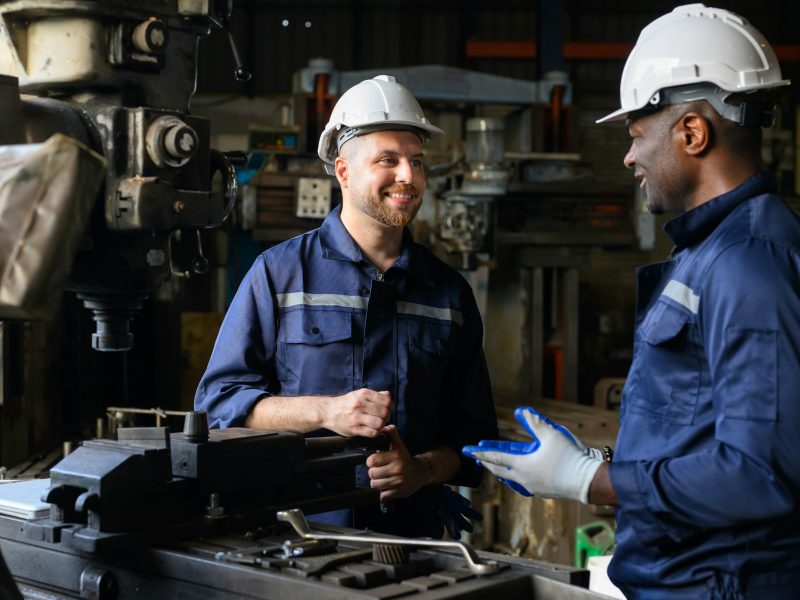 Two industrial engineers team with safety uniform